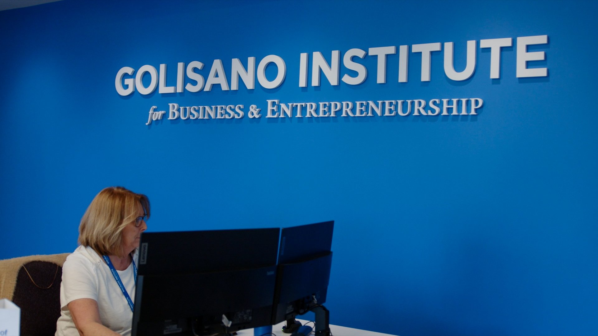 Golisano Institute staff member working on computer.